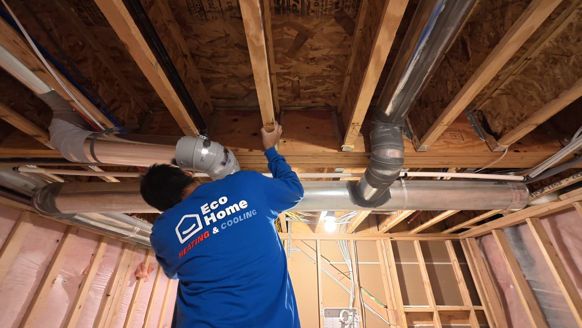 Eco Home technician installing new ductwork in a basement