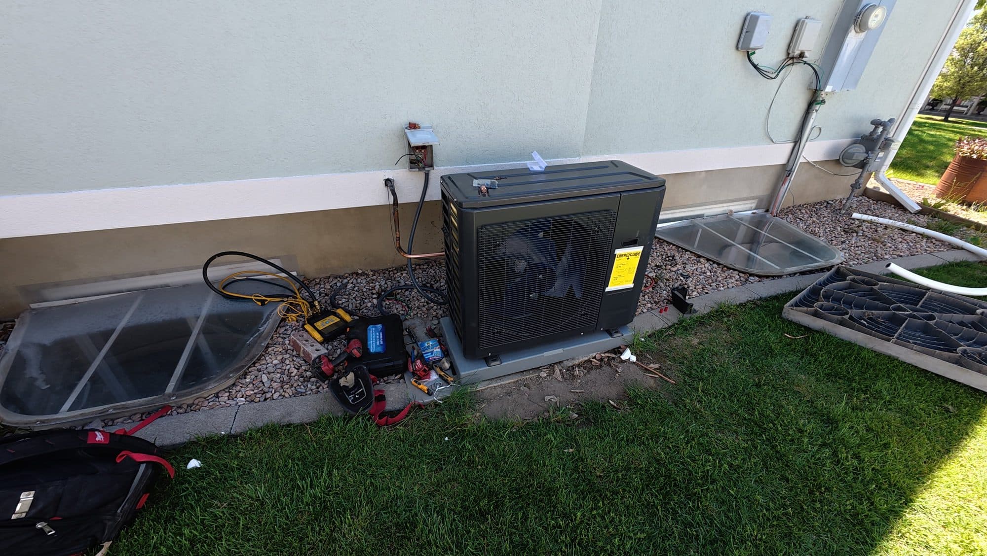 New inverter heat pump installed in place of an old air conditioner beside a Utah home