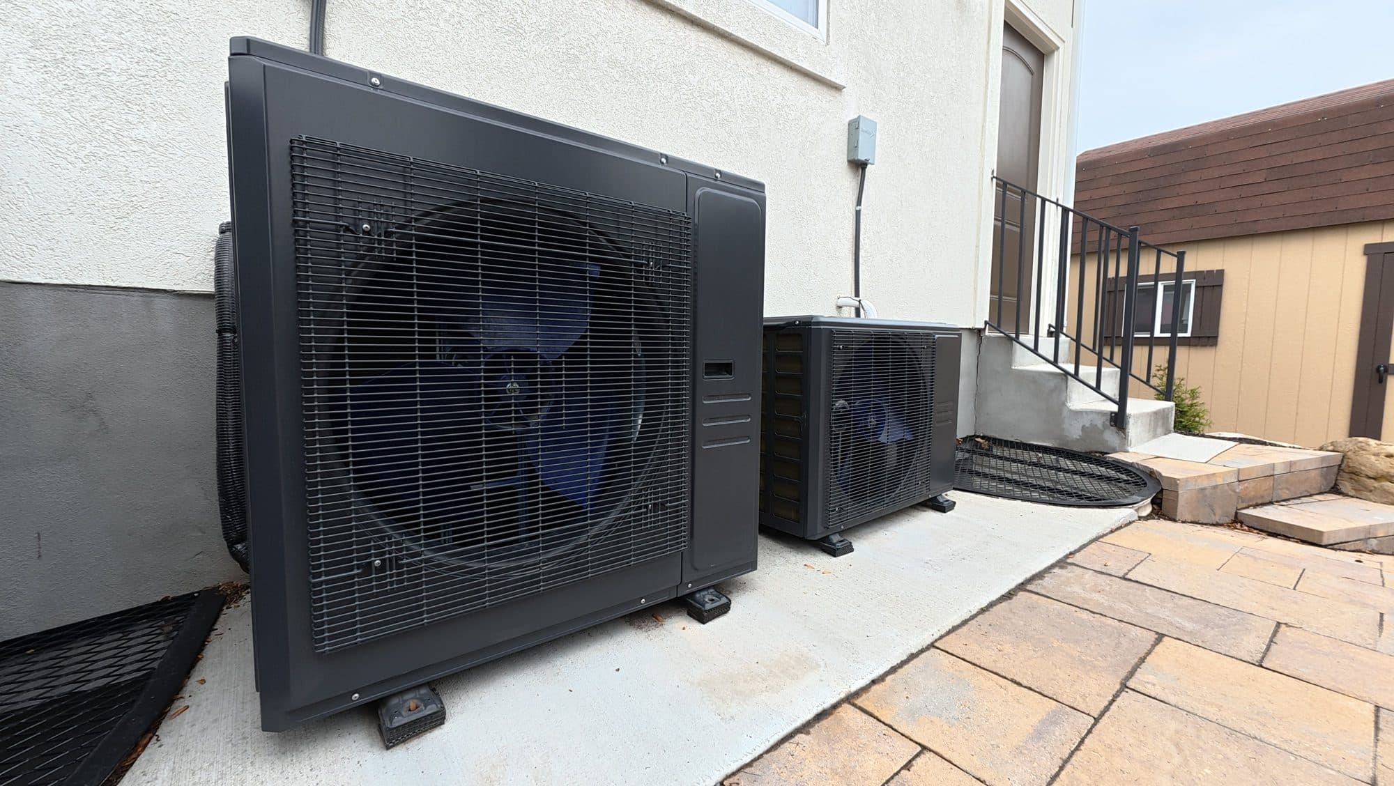 Two new heat pumps installed beside a Utah home