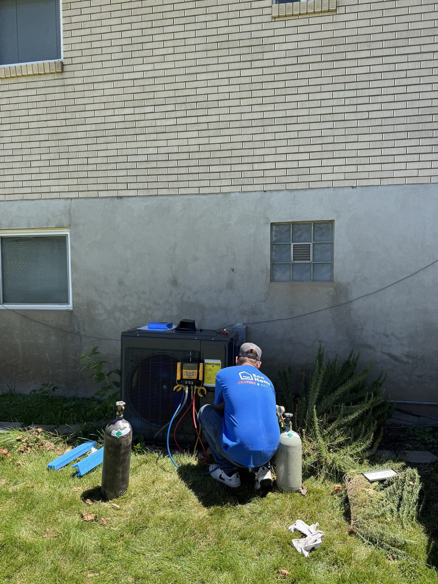 Technician checking refrigerant pressures on a heat pump