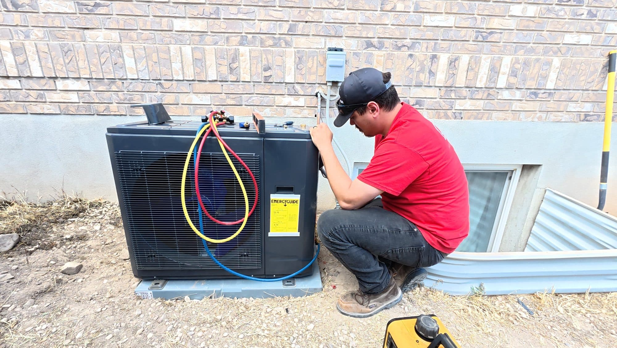 Technician installing a new heat pump